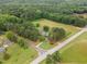 An aerial shot captures the home, its well-maintained yard, and surrounding lush greenery at 100 Martindale Dr, Youngsville, NC 27596