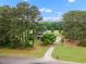 An aerial view showcasing the property's manicured lawn and mature tree coverage at 100 Martindale Dr, Youngsville, NC 27596