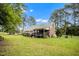 Expansive backyard featuring a covered patio and lush green lawn, perfect for outdoor enjoyment at 100 Martindale Dr, Youngsville, NC 27596