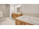 Bathroom featuring a large soaking tub, a double vanity, and a walk-in shower at 100 Martindale Dr, Youngsville, NC 27596