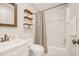 Clean bathroom with a shower/tub combo, open shelving, and modern fixtures at 100 Martindale Dr, Youngsville, NC 27596