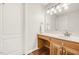 Cozy bathroom featuring wood cabinets, vanity, and stylish fixtures at 100 Martindale Dr, Youngsville, NC 27596