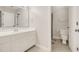 Well-lit bathroom featuring a clean vanity, a large mirror, and a convenient shower/tub combo at 100 Martindale Dr, Youngsville, NC 27596