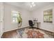 Bright bedroom featuring hardwood floors, a stylish rug, and a large window for ample natural light at 100 Martindale Dr, Youngsville, NC 27596