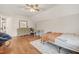 Cozy bedroom featuring wood floors, a ceiling fan, and neutral paint at 100 Martindale Dr, Youngsville, NC 27596