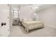 Cozy bedroom with neutral carpet and a large window offering natural light at 100 Martindale Dr, Youngsville, NC 27596