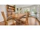 Elegant dining room featuring a large wooden table, decorative hutch, and sun-filled windows at 100 Martindale Dr, Youngsville, NC 27596