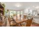 Sun-filled dining room open to kitchen with large wooden table and bright windows at 100 Martindale Dr, Youngsville, NC 27596