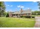 Beautiful single story brick home with mature trees and an inviting front porch at 100 Martindale Dr, Youngsville, NC 27596