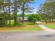 Charming single-story brick home nestled among mature trees and sprawling lawns at 100 Martindale Dr, Youngsville, NC 27596
