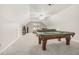 Open-concept entertainment room featuring a classic pool table, cozy sectional sofa, and well-lit interiors at 100 Martindale Dr, Youngsville, NC 27596