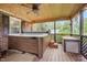 Outdoor hot tub on a screened-in porch, creating a relaxing retreat at 100 Martindale Dr, Youngsville, NC 27596
