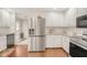 Kitchen with stainless steel refrigerator, white cabinetry and tile backsplash at 100 Martindale Dr, Youngsville, NC 27596