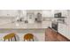 Bright kitchen featuring stainless steel appliances, white cabinets and granite countertops with breakfast bar at 100 Martindale Dr, Youngsville, NC 27596