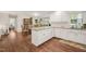 Bright eat-in kitchen with white cabinetry, granite countertops, and wooden floors at 100 Martindale Dr, Youngsville, NC 27596