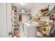 A functional laundry room featuring a washer, dryer and plenty of shelf space for optimal storage solutions at 100 Martindale Dr, Youngsville, NC 27596