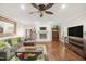 Bright living room with fireplace, ceiling fan and ample seating creating a cozy atmosphere at 100 Martindale Dr, Youngsville, NC 27596