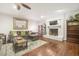 Cozy living room featuring a fireplace, ceiling fan and comfortable seating at 100 Martindale Dr, Youngsville, NC 27596