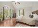 Airy main bedroom with vaulted ceilings, large arched windows, and wood flooring at 100 Martindale Dr, Youngsville, NC 27596