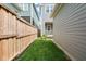 Green backyard with wood fence and lush grass, offering a private outdoor space at 1006 Whistler St, Durham, NC 27713