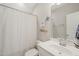 Bathroom with a toilet, white vanity, and a shower curtain, showcasing practicality and a clean aesthetic at 1006 Whistler St, Durham, NC 27713
