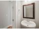 Bright powder room features a pedestal sink and hardwood floors at 1006 Whistler St, Durham, NC 27713