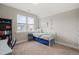 Neutral bedroom showcasing a charming single bed and a window that allows for plenty of natural light at 1006 Whistler St, Durham, NC 27713