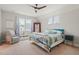 Bright bedroom with a ceiling fan, large windows, and colorful bedding at 1006 Whistler St, Durham, NC 27713