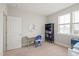 Neutral bedroom features a desk, shelves, and natural light from a window, creating a cozy workspace at 1006 Whistler St, Durham, NC 27713