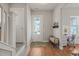 Inviting entryway features a bench, desk, and a view of the bright and sunny neighborhood at 1006 Whistler St, Durham, NC 27713