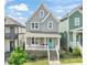 Charming two-story home featuring a welcoming front porch and stylish, gray siding at 1006 Whistler St, Durham, NC 27713