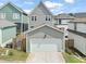 Two-story home featuring an attached two-car garage and a well-manicured lawn at 1006 Whistler St, Durham, NC 27713