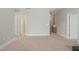 A view of the hallway with carpeted flooring and doors leading to various rooms, creating smooth transitions at 1006 Whistler St, Durham, NC 27713