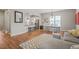 Bright living room offers hardwood floors, a comfortable sofa, and an open view into the modern kitchen at 1006 Whistler St, Durham, NC 27713