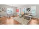 Bright living room features hardwood floors, a gray sectional sofa, and modern decor at 1006 Whistler St, Durham, NC 27713