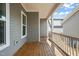 Covered porch with wood floors provides an outdoor living space with view of the backyard at 1006 Whistler St, Durham, NC 27713