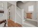 Neutral stairway boasts white railings and hardwood floors, leading to the upper level at 1006 Whistler St, Durham, NC 27713