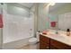Bathroom with white tub, white toilet, dark brown vanity and green walls at 102 Mikaila Dr, Gibsonville, NC 27249