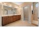 Bathroom with double sink vanity, large mirror and tiled shower at 102 Mikaila Dr, Gibsonville, NC 27249