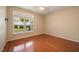 Bedroom with hardwood floors, large window, and neutral paint at 102 Mikaila Dr, Gibsonville, NC 27249