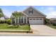 Charming home showcasing a well-manicured lawn, complemented by stone and siding accents at 102 Mikaila Dr, Gibsonville, NC 27249