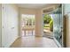 Welcoming foyer with tile transitioning to hardwood and a view of the sunroom at 102 Mikaila Dr, Gibsonville, NC 27249
