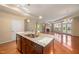 Open kitchen with granite countertops and stainless steel appliances overlooking the living room with a fireplace at 102 Mikaila Dr, Gibsonville, NC 27249