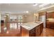 Open kitchen with island sink, granite countertops, and stainless steel refrigerator at 102 Mikaila Dr, Gibsonville, NC 27249