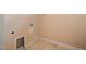 Compact laundry area with utility connections, baseboards, and tiled floors at 102 Mikaila Dr, Gibsonville, NC 27249