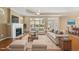 Staged living room with fireplace, plush seating, and light-filled windows at 102 Mikaila Dr, Gibsonville, NC 27249