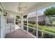 Screened porch with ceiling fan overlooking a well-manicured lawn and landscaping at 102 Mikaila Dr, Gibsonville, NC 27249