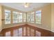 Light-filled sunroom featuring polished hardwood floors and multiple windows at 102 Mikaila Dr, Gibsonville, NC 27249