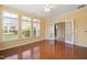 Sunroom with hardwood floors, a ceiling fan, and double doors opening into another room at 102 Mikaila Dr, Gibsonville, NC 27249