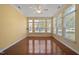Bright, sun-drenched sunroom with gleaming hardwood floors and large windows at 102 Mikaila Dr, Gibsonville, NC 27249